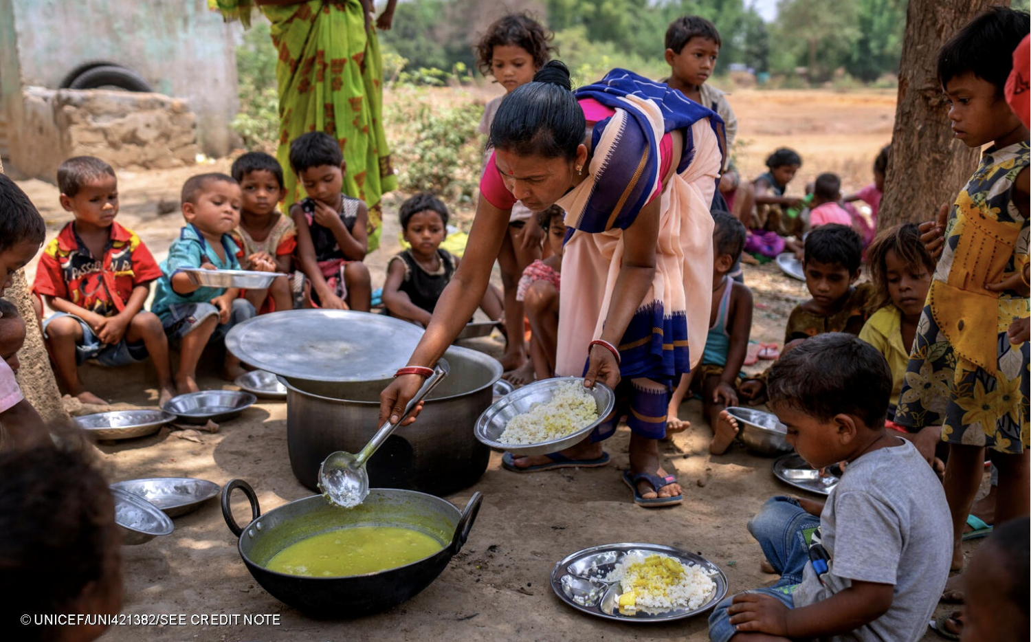 Cover image for the resource depicting an anganwadi worker serving rice & lentils to children during Village Health and Nutrition Day (VHND) in Baliadih village, West Singhbhum, Jharkhand state, India